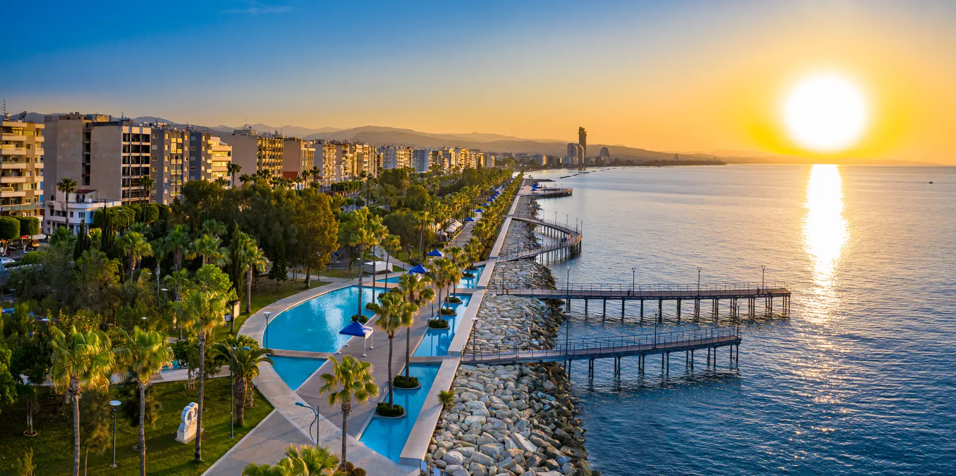 Sunset over Limassol Marina with golden light across the sea and skyline